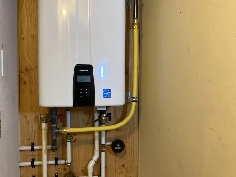 Technician repairing a leaking tankless water heater in Highland, CA 92346