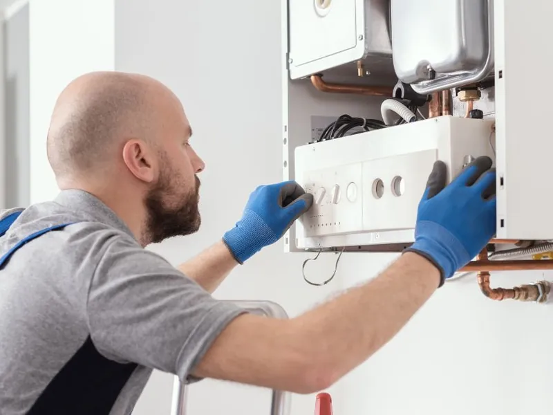 Technician replacing a water heater thermostat in Moreno Valley, CA 92555
