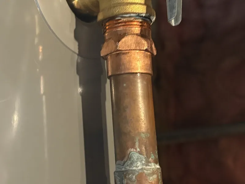 Technician replacing a TPR relief valve on a water heater in Grand Terrace, CA 92313